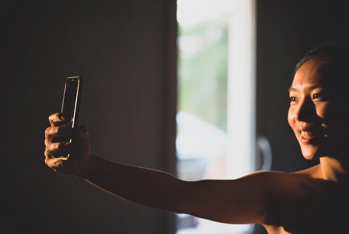 Person taking a selfie with good lighting for AI photo generation
